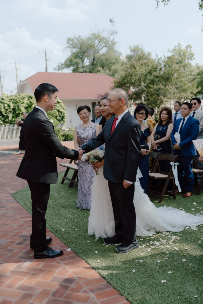 Lucinda’s dad walking her down the aisle at Woodbine Mansion wedding ceremony

