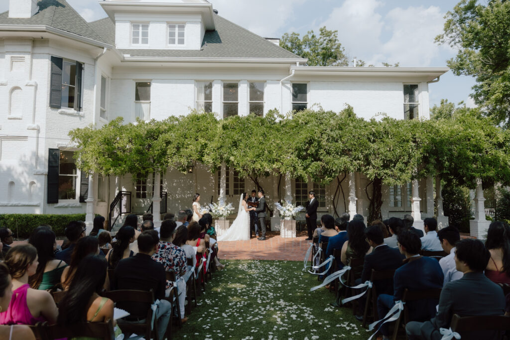 Wide angle shot of Lucinda and Matthew’s wedding ceremony on the west lawn at Woodbine Mansion
