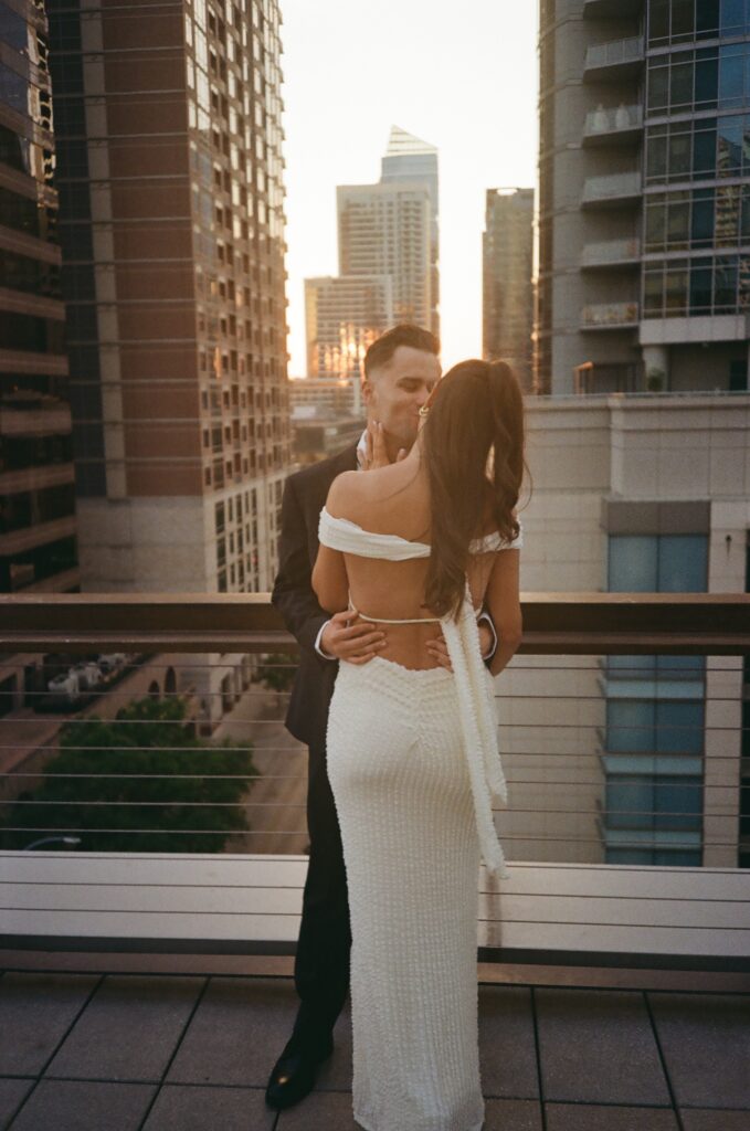 Film photo of couple dancing around the sunset at their engagement session