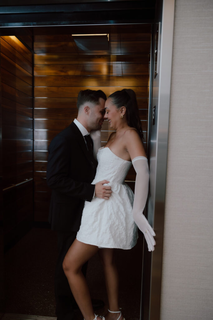 Jared and Marley riding the hotel elevator together on their Austin engagement session, excited for their rooftop date night photoshoot.