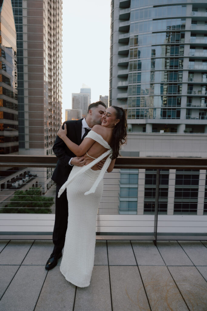 Rooftop photo of couple dancing around their engagement session in Austin Texas