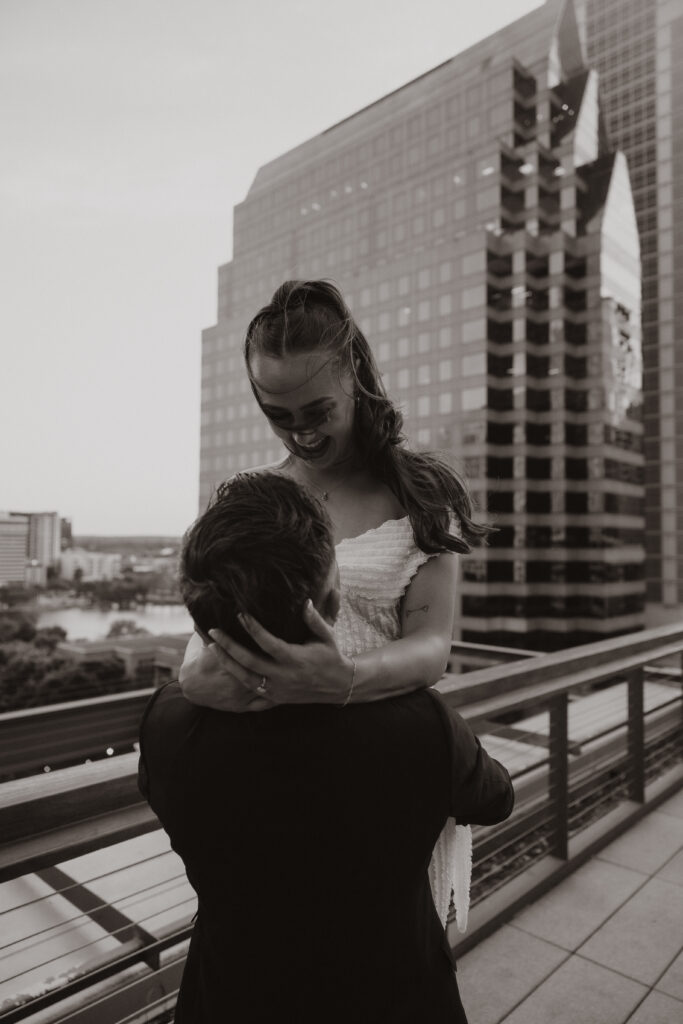 Jared picking up and spinning Marley with joyful energy during their Austin engagement session
