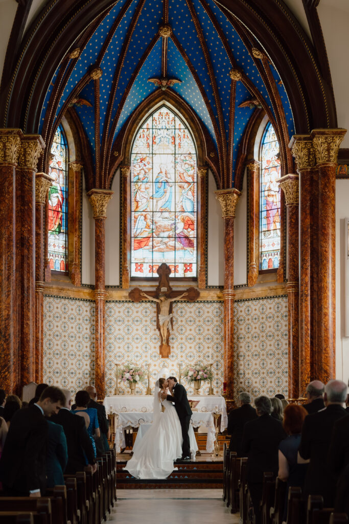 Corrine and George sharing their first kiss as husband and wife at St. Mary’s Cathedral in Austin, Texas.