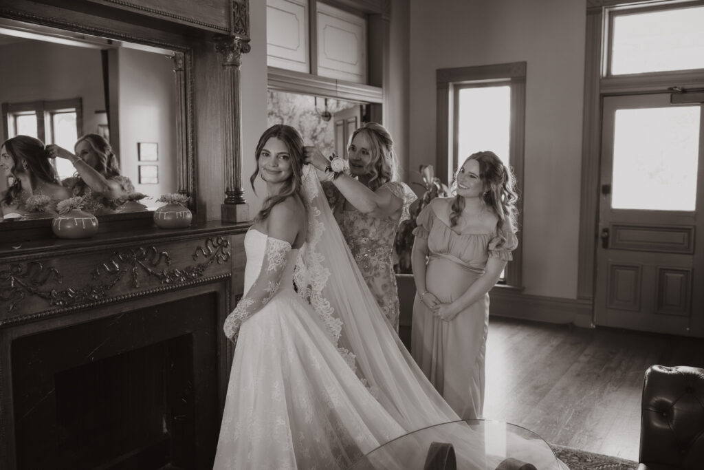 Mallory getting ready in the bridal suite at Mattie’s at Green Pastures with her mom and sister
Title: Mallory Wedding Prep Photos By Tia