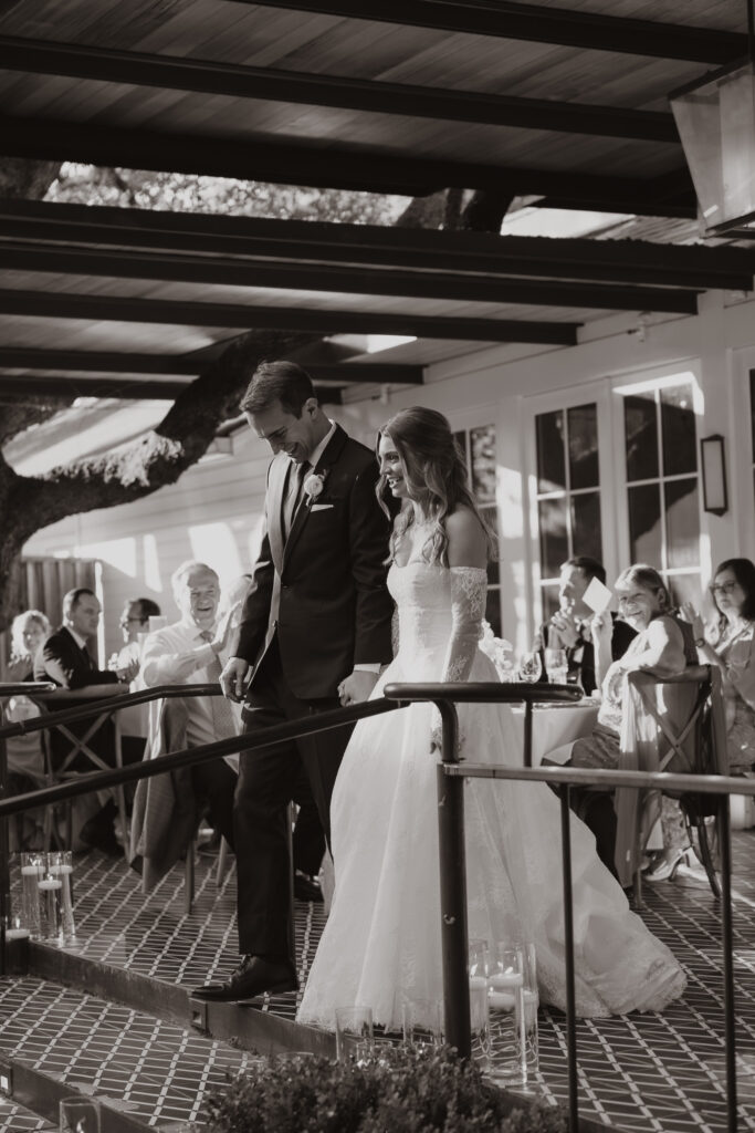Mallory and Reese entering their wedding reception 
